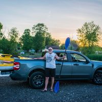 Kayaker standing with paddle and kayaks at the Buckeye Lake Canoe and Kayak Launch in Thornville, Perry County, Ohio.