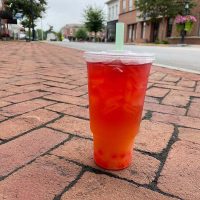 Red beverage sitting on sidewalk outside Generally Fit, a smoothie, tea and coffee shop in Somerset, Perry County, Ohio.