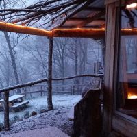 Winter scene with snow and outdoor fire at Hidden Gems Cabins in New Lexington, Perry County, Ohio.