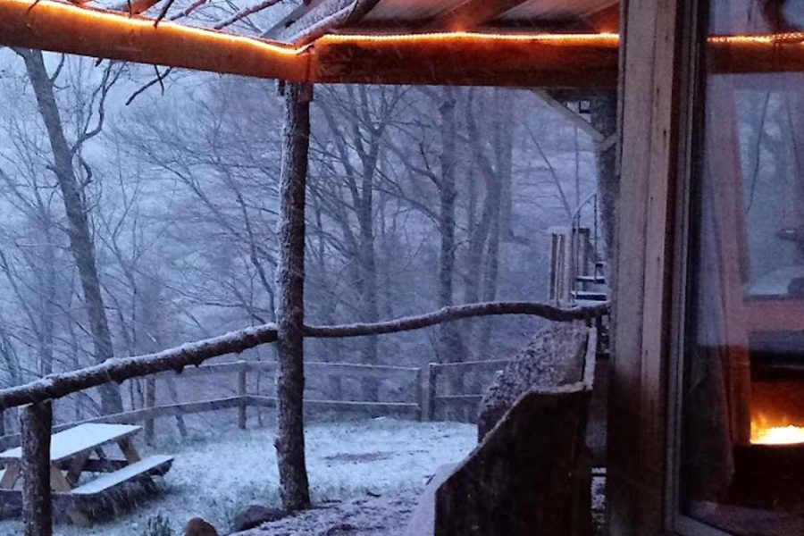 Winter scene with snow and outdoor fire at Hidden Gems Cabins in New Lexington, Perry County, Ohio.