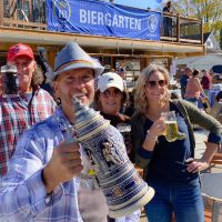 People holding up tankards of beer on a patio under an Oktoberfest banner at Horvath's Harbor, Thornville, Perry County, Ohio.