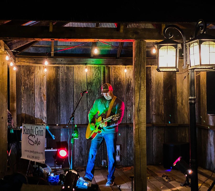 Guitarist playing at night on patio stage at Horvath's Harbor in Thornville, Perry County, Ohio.