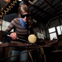 Artist working ball of glass