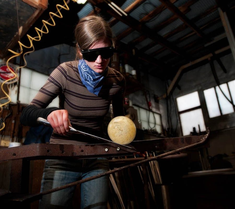 Artist working ball of glass