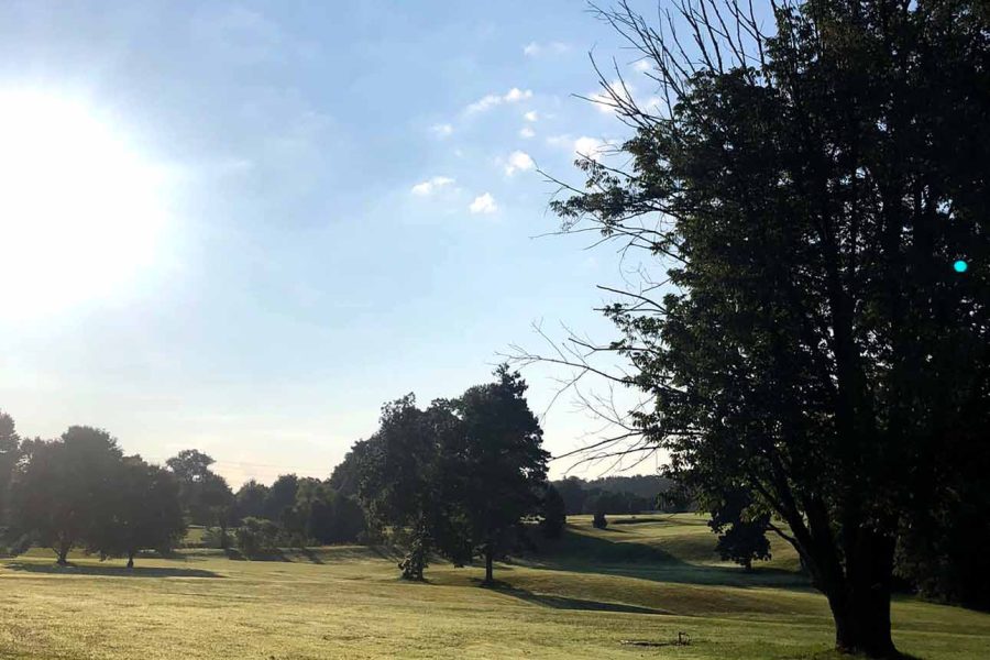 Daybreak on rolling greens with trees at Perry Country Club, New Lexington, Perry County, Ohio.