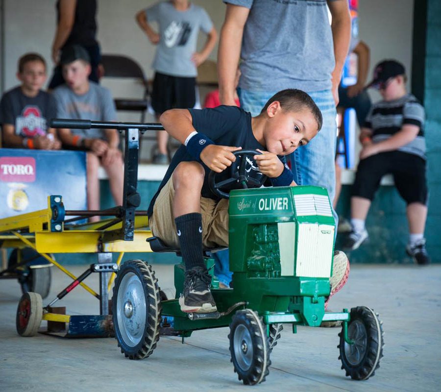 Child riding miniature tractor at the Perry County Fair in New Lexington, Ohio