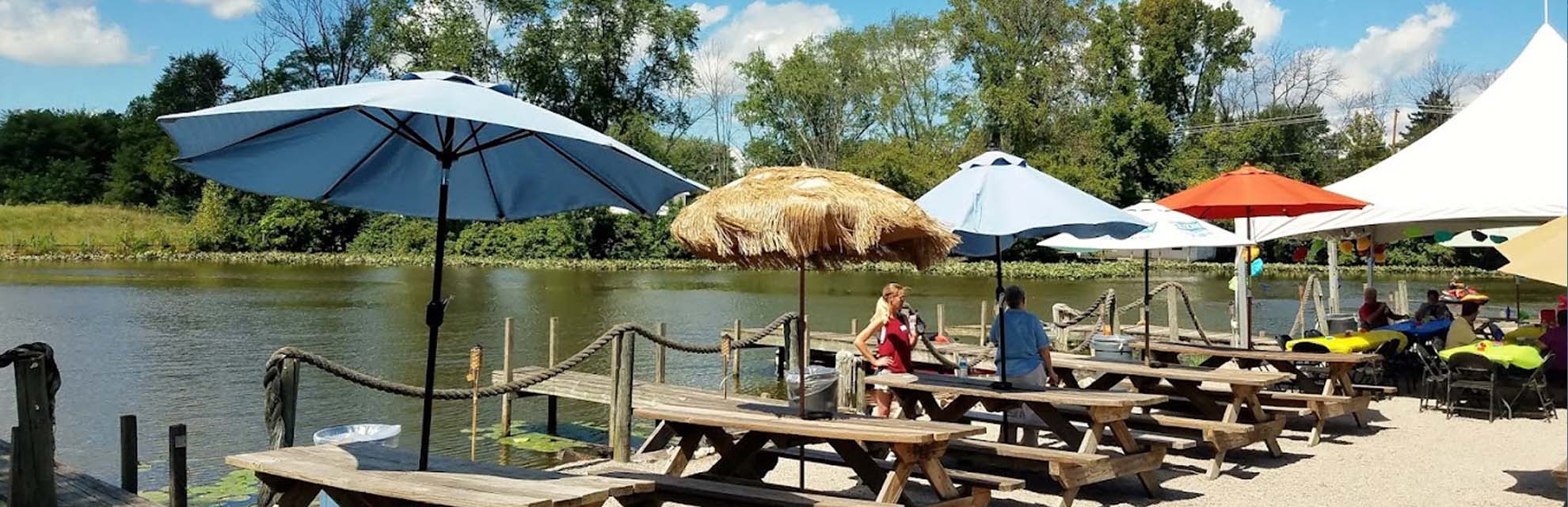 Dockside picnic tables with umbrellas at The Port Lounge & Smokehouse in Thornville, Perry County, Ohio.