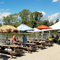 Dockside picnic tables with umbrellas at The Port Lounge & Smokehouse in Thornville, Perry County, Ohio.