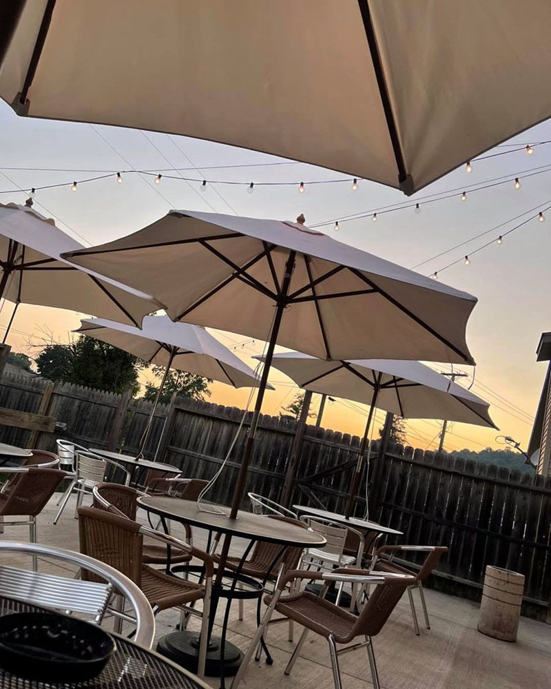 Dusk on the patio with umbrella tables at The Hangout in Crooksville, Perry County, Ohio.