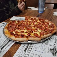 Guest enjoying a pepperoni pizza at The Pizza Place in New Lexington, Perry County, Ohio.