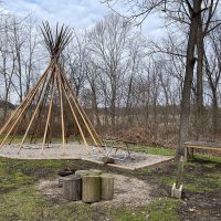 Tipi with log seating and fire pits at Cherokee Valley Bison Ranch