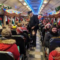 Conductor collecting fares on the Christmas Train operated by the Zanesville and Western Scenic Railroad in Perry County, Ohio.