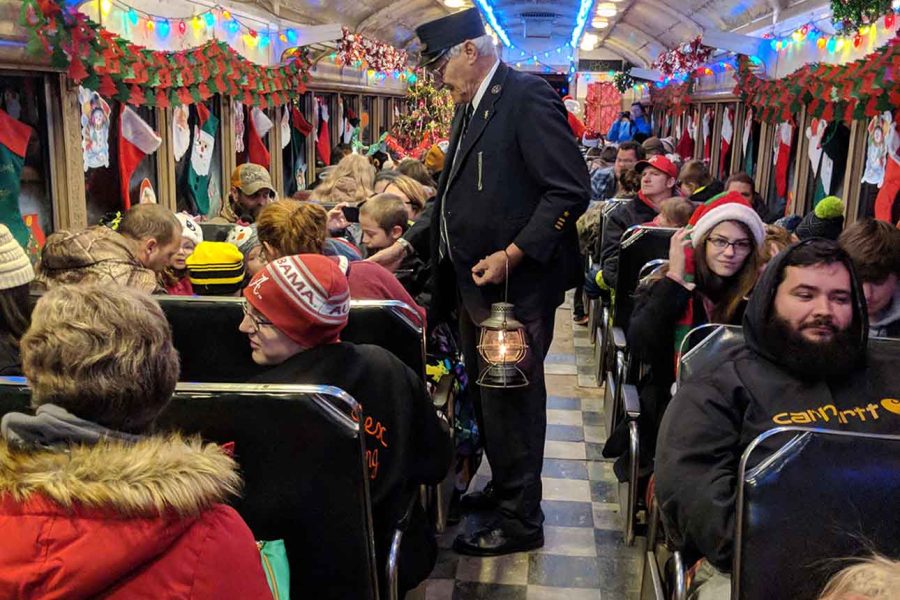 Conductor collecting fares on the Christmas Train operated by the Zanesville and Western Scenic Railroad in Perry County, Ohio.