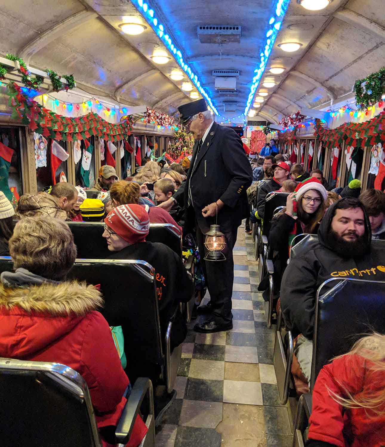 Conductor collecting fares on the Christmas Train operated by the Zanesville and Western Scenic Railroad in Perry County, Ohio.