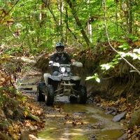 Person riding an ATV through Perry State Forest in Perry County, Ohio