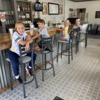 Four children seated at the lunch counter at The Corner News in downtown New Lexington, Perry County, Ohio