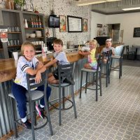 Four children seated at the lunch counter at The Corner News in downtown New Lexington, Perry County, Ohio