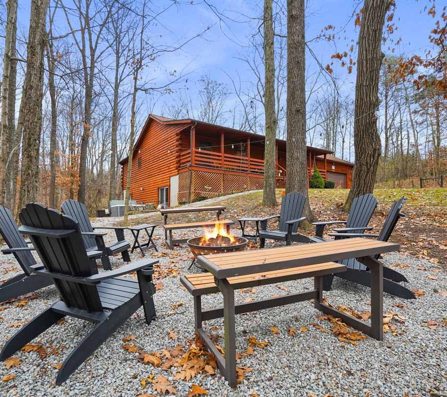 Rear exterior of Honeybee Hideaway lodging with chairs and fire pit in Logan, Monday Creek, southern Perry County, Ohio