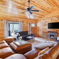 Living room with mounted television and fireplace at Honeybee Hideaway in Logan, Monday Creek, southern Perry County, Ohio