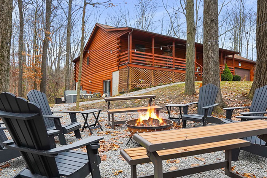 Rear exterior of Honeybee Hideaway lodging with chairs and fire pit in Logan, Monday Creek, southern Perry County, Ohio