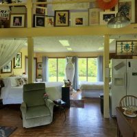 Artist's space accommodations with bed, kitchen and artwork on display at Acres of Nature in Perry County, Ohio.