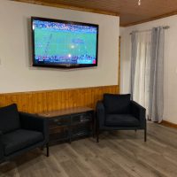 Living room with large screen tv in Woodacre Place cabin in Perry County, Ohio.