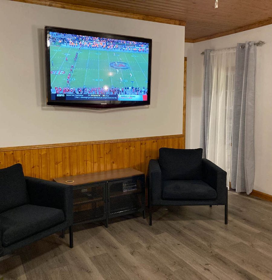 Living room with large screen tv in Woodacre Place cabin in Perry County, Ohio.