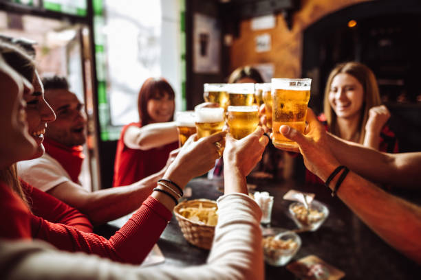 people talking toasting in a pub with the beers